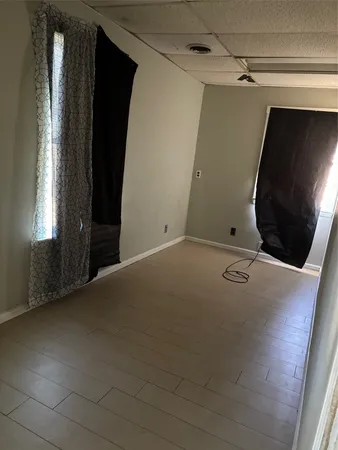 a view of room with stairs and wooden floor