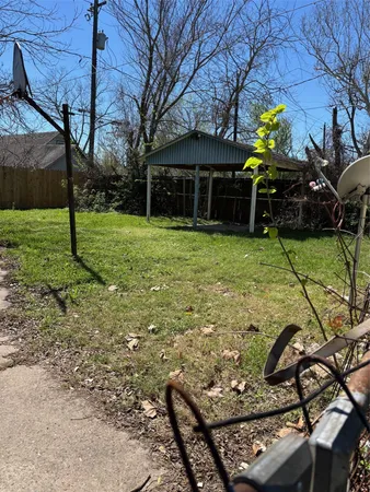 a backyard of a house with barbeque oven table and chairs