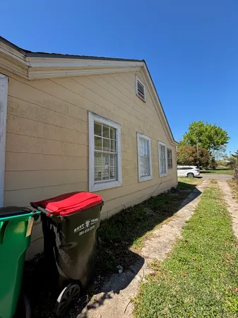 a view of a house with backyard and sitting area