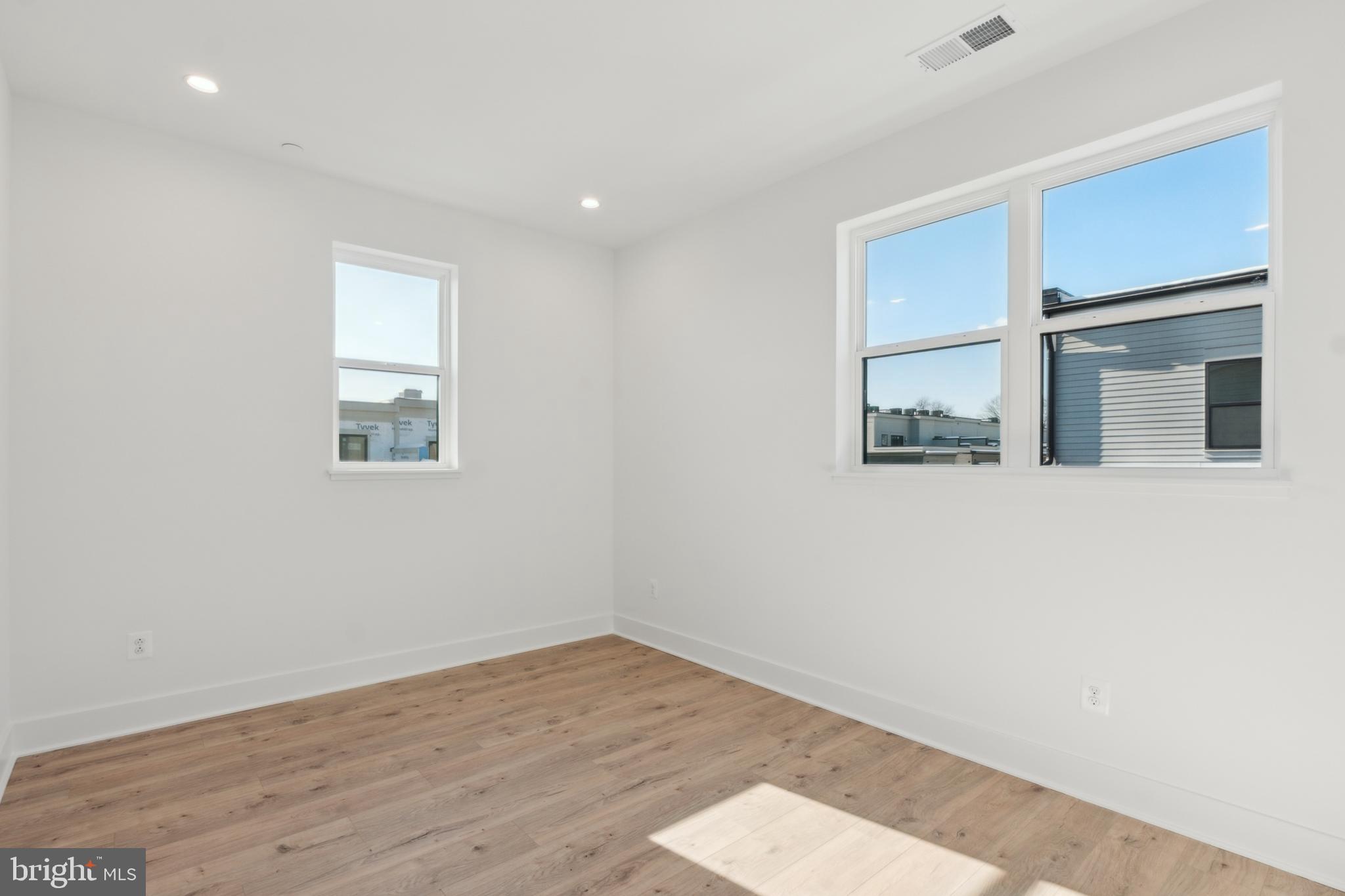 2106 Tysons Ridgeline Road Falls Church, VA 22043 - Photo 34 of 47 an empty room with wooden floor and windows