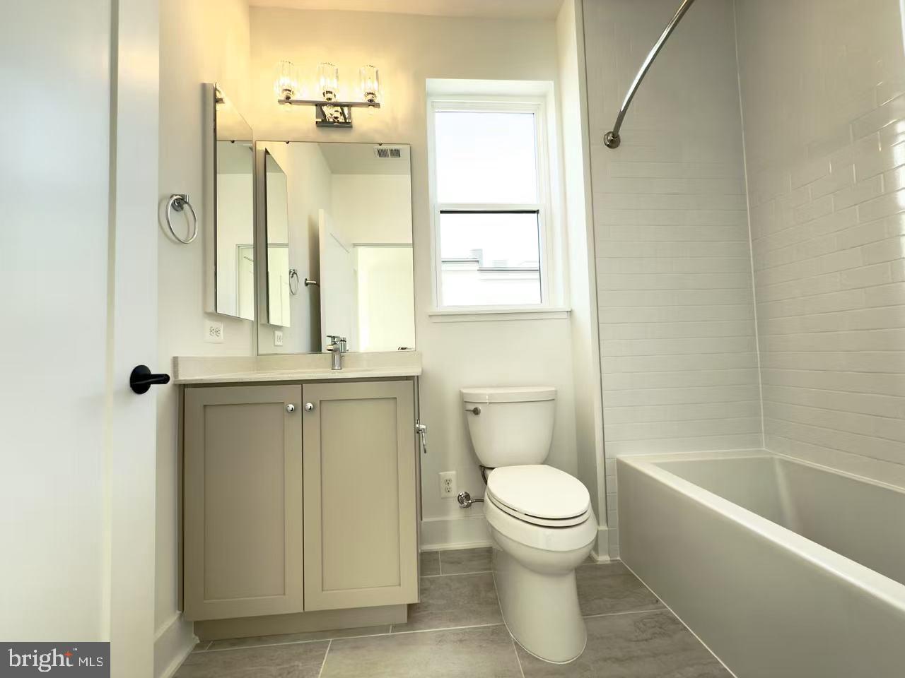 2106 Tysons Ridgeline Road Falls Church, VA 22043 - Photo 36 of 47 a bathroom with a granite countertop toilet a sink and a bathtub