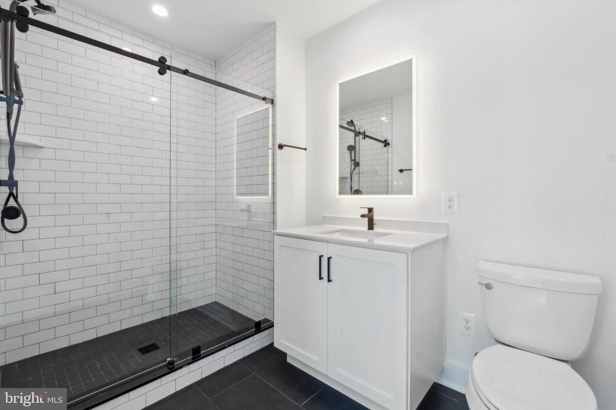 2106 Tysons Ridgeline Road Falls Church, VA 22043 - Photo 4 of 47 a bathroom with a sink a toilet and shower