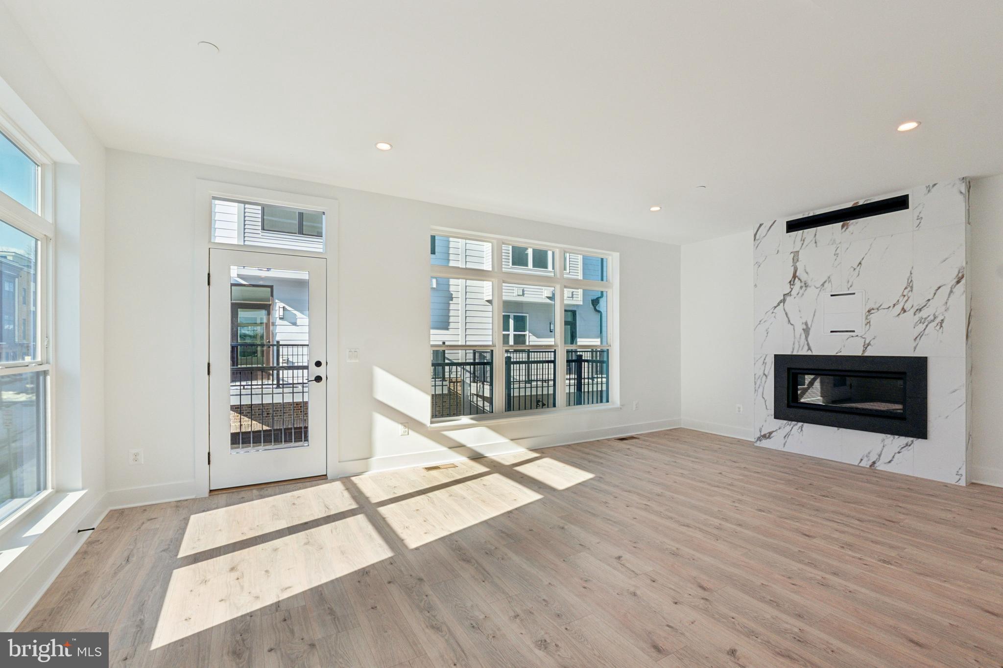 2106 Tysons Ridgeline Road Falls Church, VA 22043 - Photo 6 of 47 a view of empty room with wooden floor and fireplace