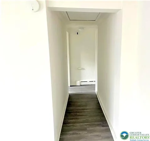 a view of a hallway with wooden floor
