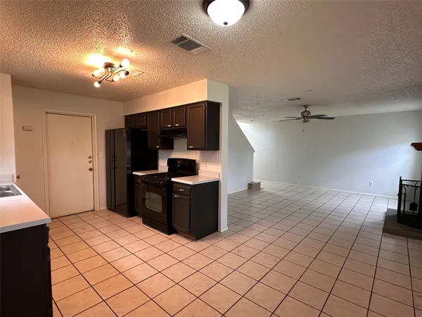 a kitchen with a sink cabinets and window