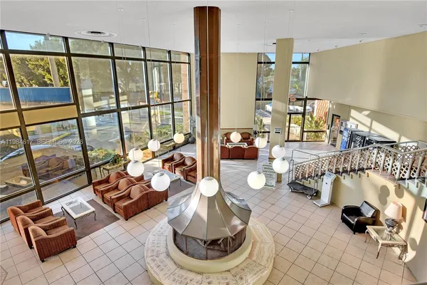 a living room with furniture and a floor to ceiling window