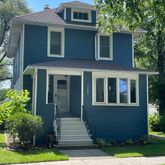 a view of a brick house with a yard