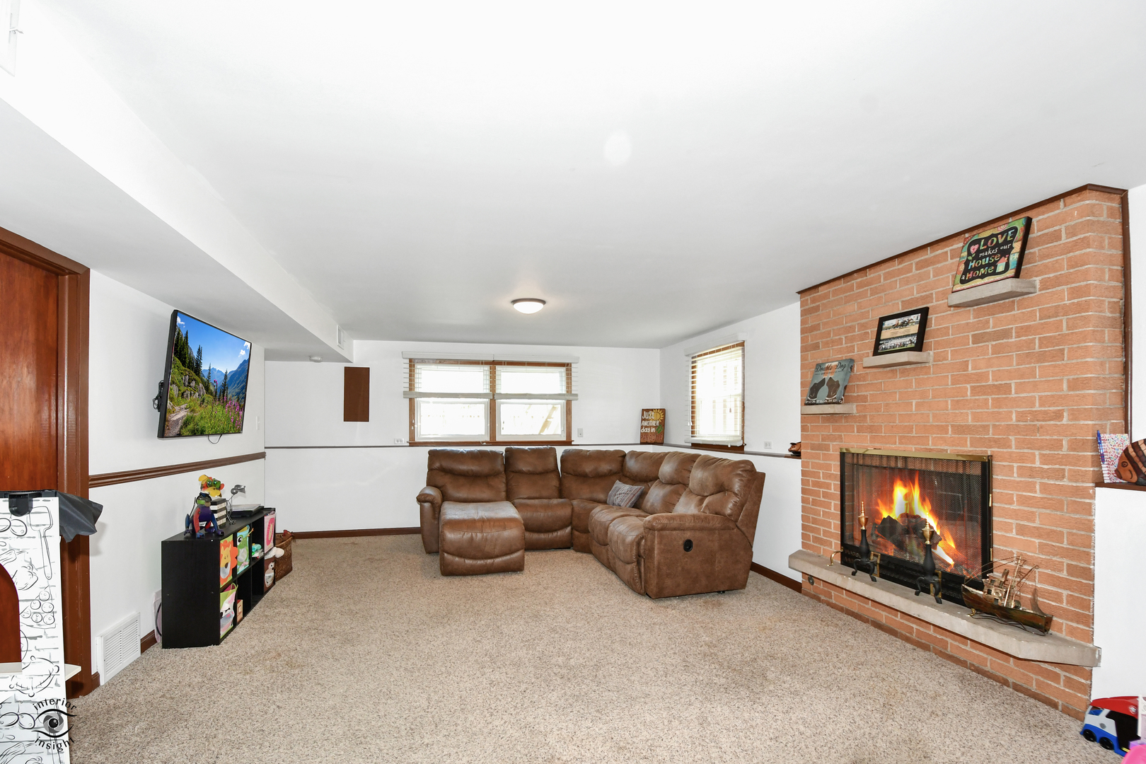 802 Timber Lane Darien, IL 60561 - Photo 11 of 23 a living room with furniture a flat screen tv and a fireplace