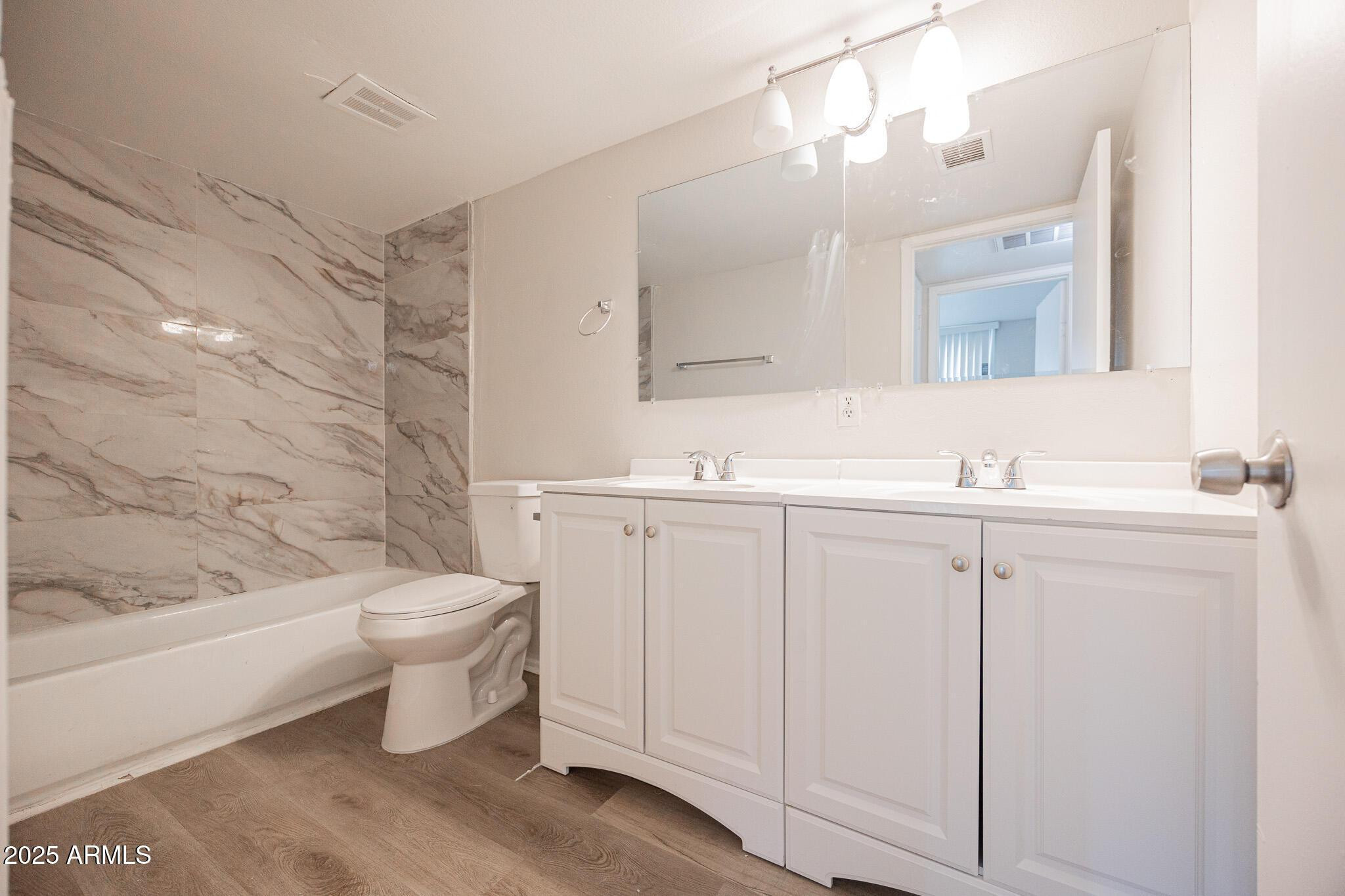 2352 East Broadway Road, Unit A Mesa, AZ 85204 - Photo 9 of 14 a bathroom with a toilet sink and mirror