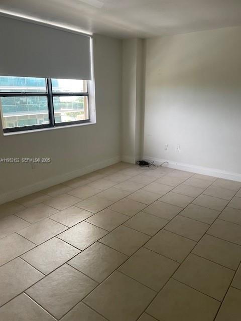 10185 Collins Avenue, Unit 321 Bal Harbour, FL 33154 - Photo 10 of 17 a view of an empty room with a window