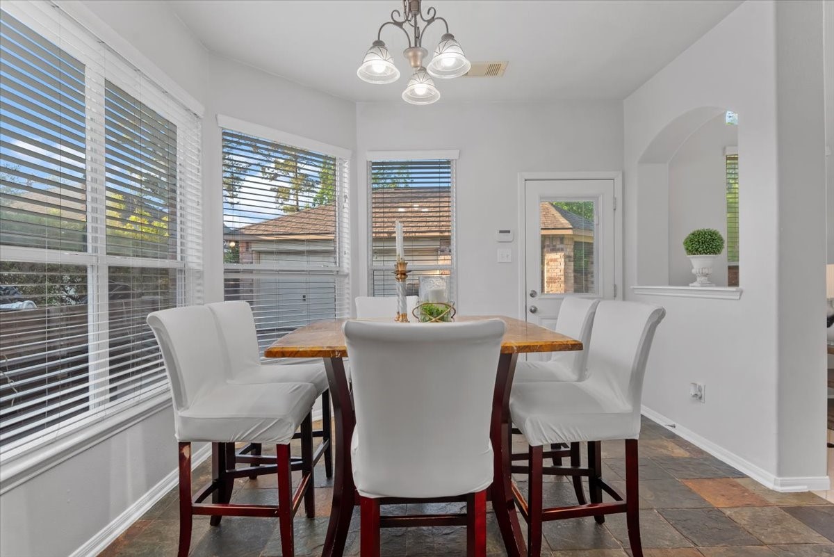6507 Quiet Pointe Drive Spring, TX 77389 - Photo 9 of 45 Bright breakfast room area with large windows, natural light, and a view of the backyard.