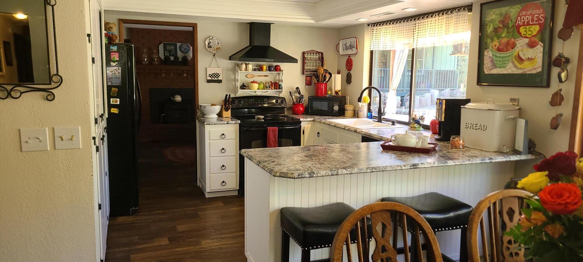 308 Fir Canyon Road Grants Pass, OR 97527 - Photo 11 of 51 KITCHEN WITH A WALL OF CABINETS TO THE LEFT