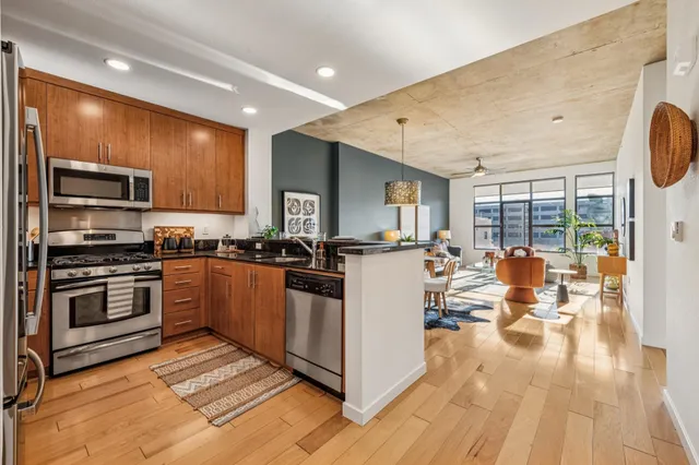 a living room with stainless steel appliances granite countertop lots of counter top space and furniture