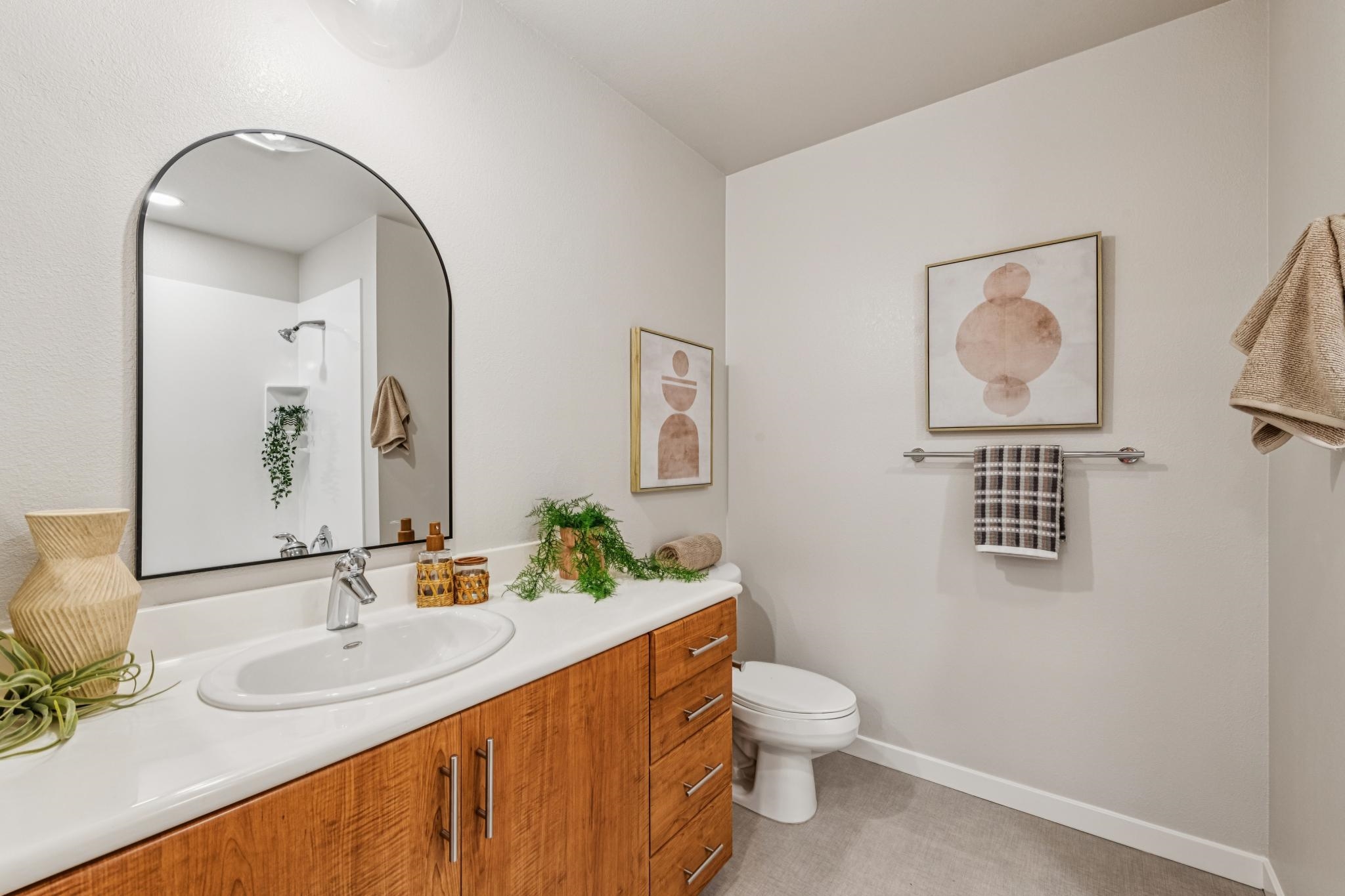 288 3rd Street, Unit 406 Oakland, CA 94607 - Photo 16 of 32 a bathroom with a toilet a sink and mirror