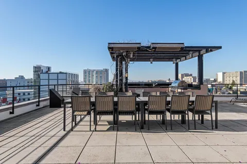 a view of a patio with table and chairs