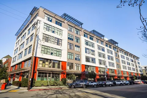 a view of a street with cars and a building