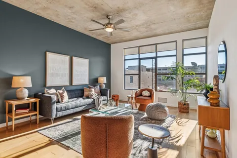 a living room with furniture and a large window