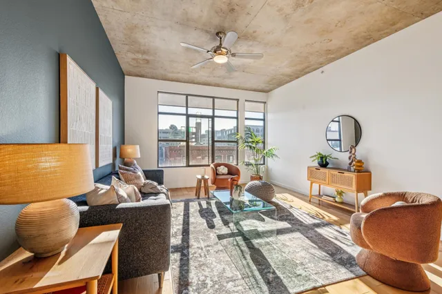 a living room with furniture and floor to ceiling windows