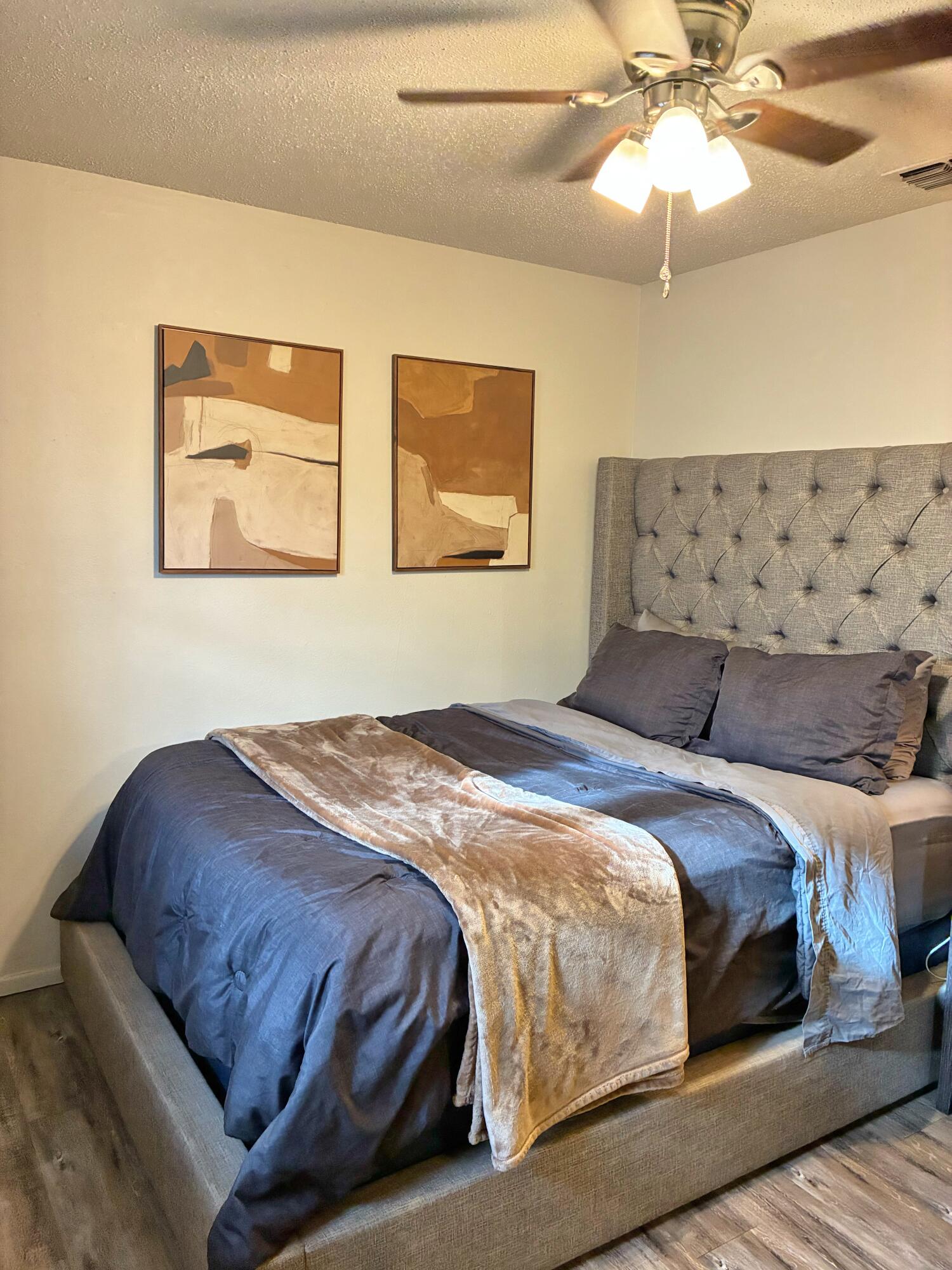 4203 17th Street Lubbock, TX 79416 - Photo 11 of 15 a bedroom with a bed and lamp