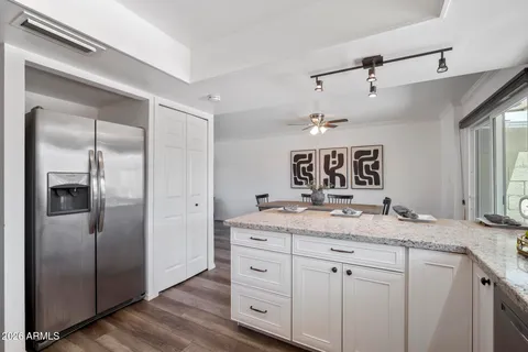 a kitchen with stainless steel appliances granite countertop a sink a stove and cabinets