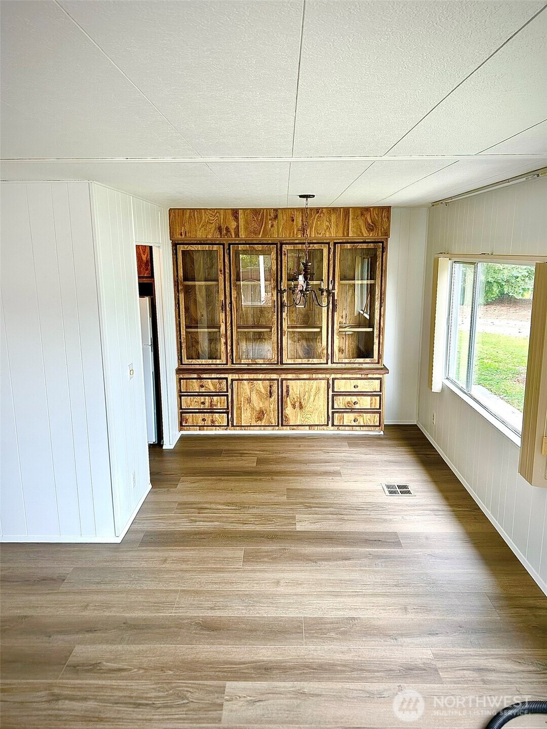 791 Elliot Court Sequim, WA 98382 - Photo 9 of 37 a view of an empty room with wooden floor and a window