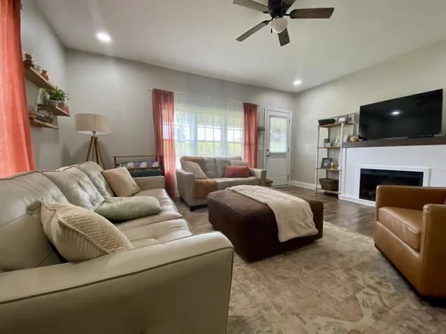 a living room with furniture and a large window