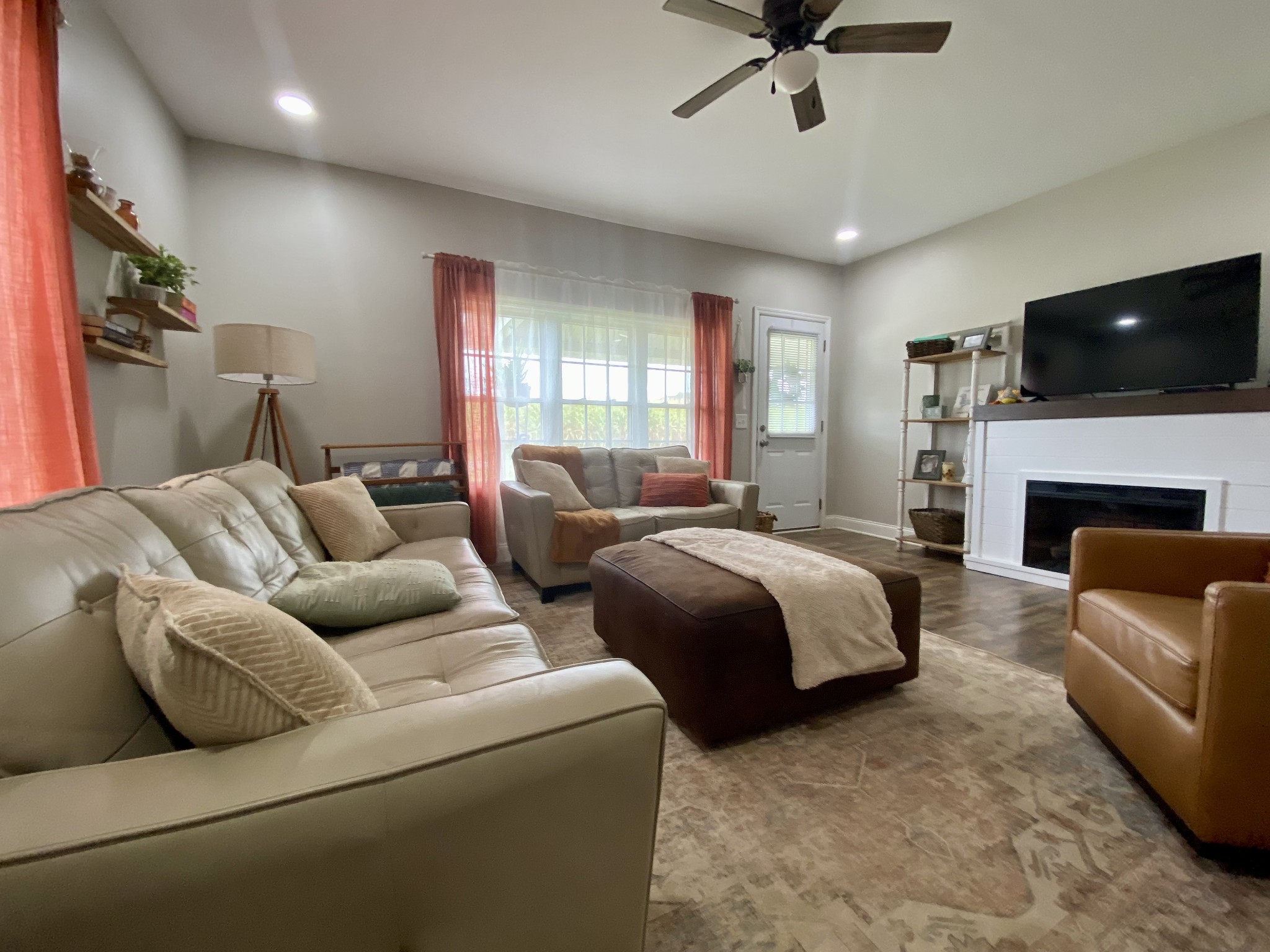 308 Spring Street Loretto, TN 38469 - Photo 13 of 28 a spacious bedroom with a bed a couch and a fireplace