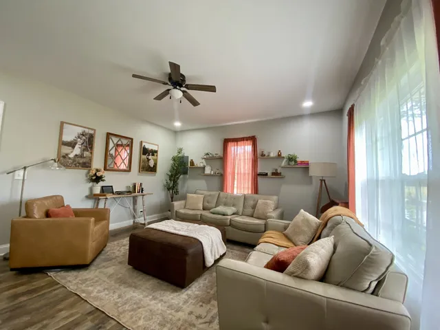 a living room with furniture a fireplace and a flat screen tv