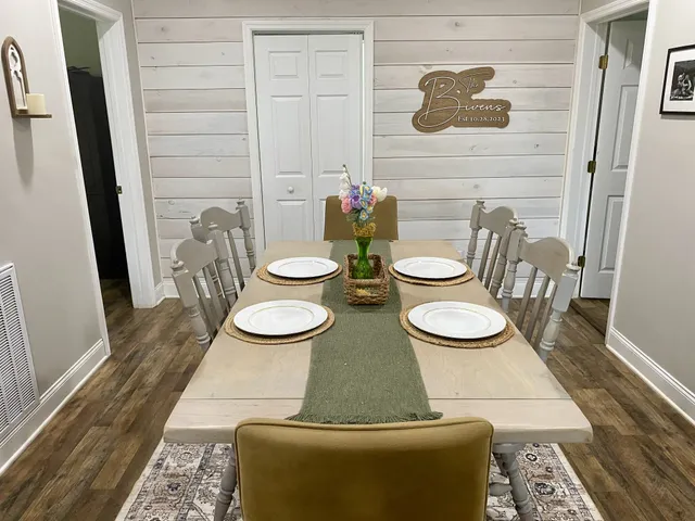 a dining room with furniture and a wooden floor