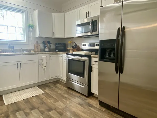 a kitchen with a sink window and cabinets