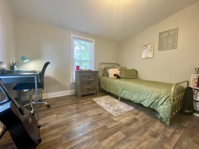 a bedroom with a bed and a desk