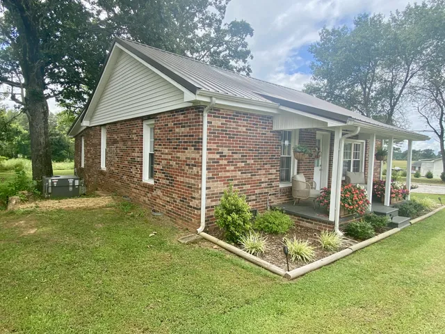 a view of house with backyard