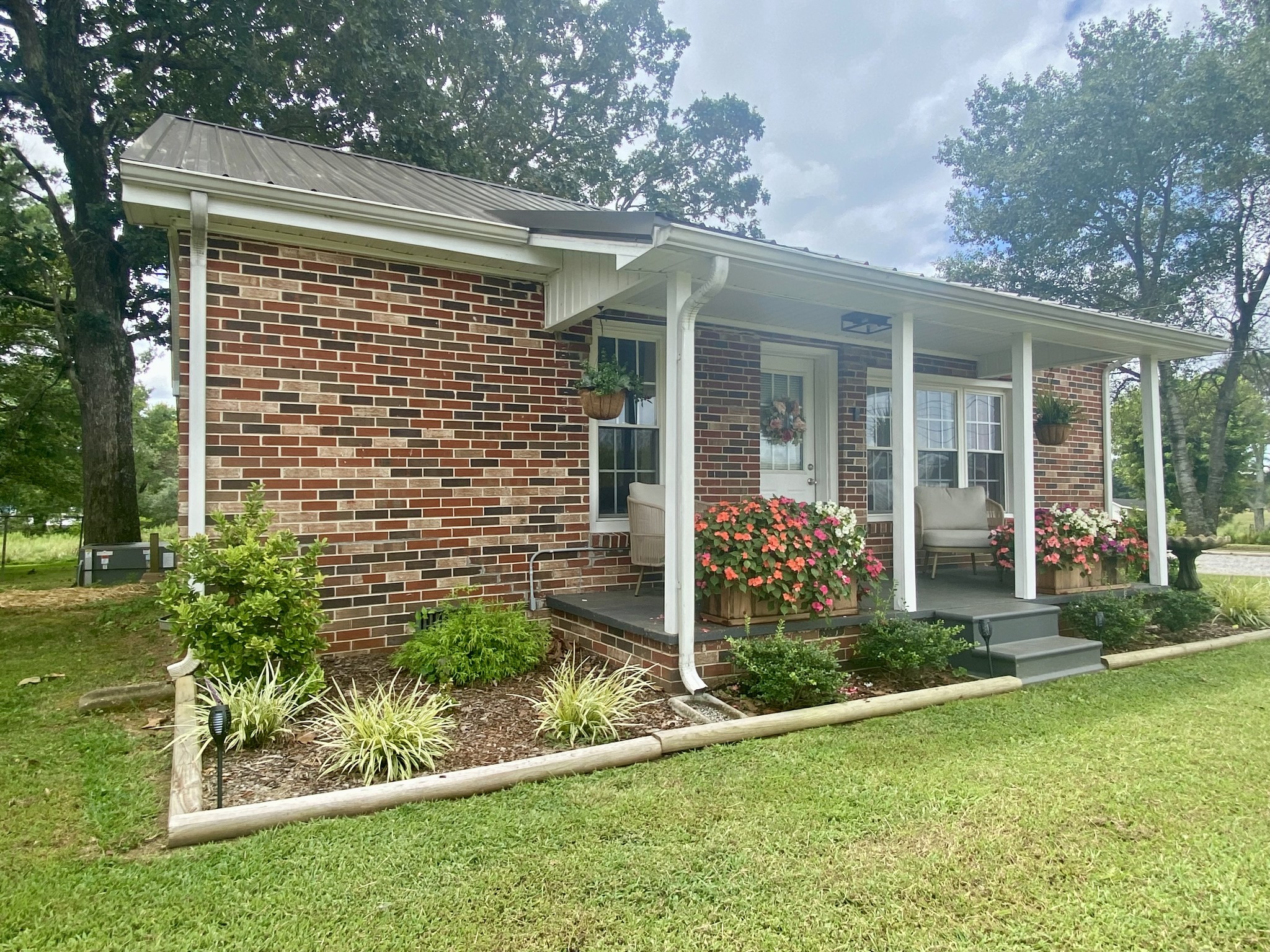 308 Spring Street Loretto, TN 38469 - Photo 6 of 28 a front view of a house with garden
