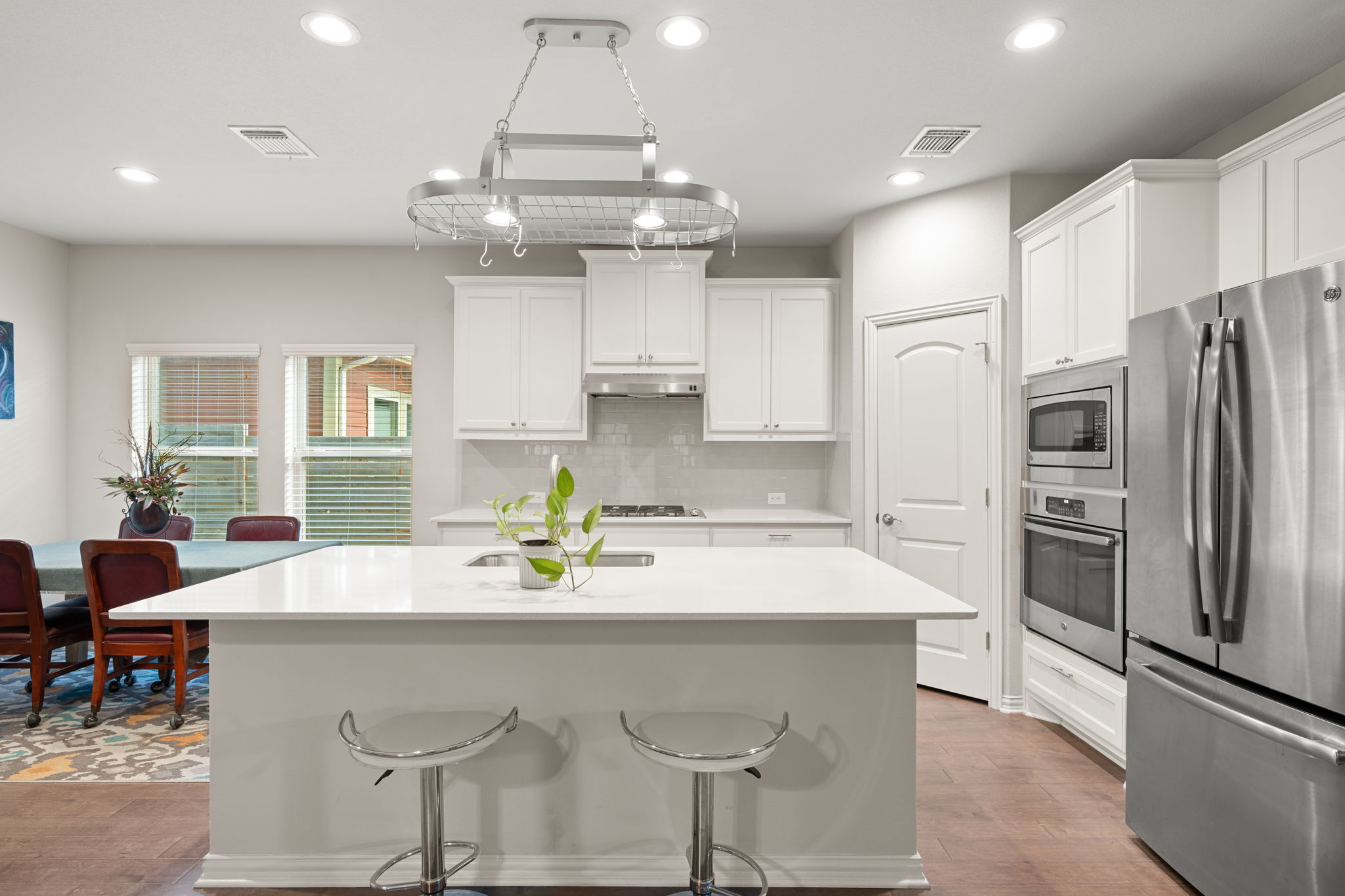 8800 Slater Drive Austin, TX 78747 - Photo 7 of 40 a kitchen with stainless steel appliances a dining table chairs and refrigerator