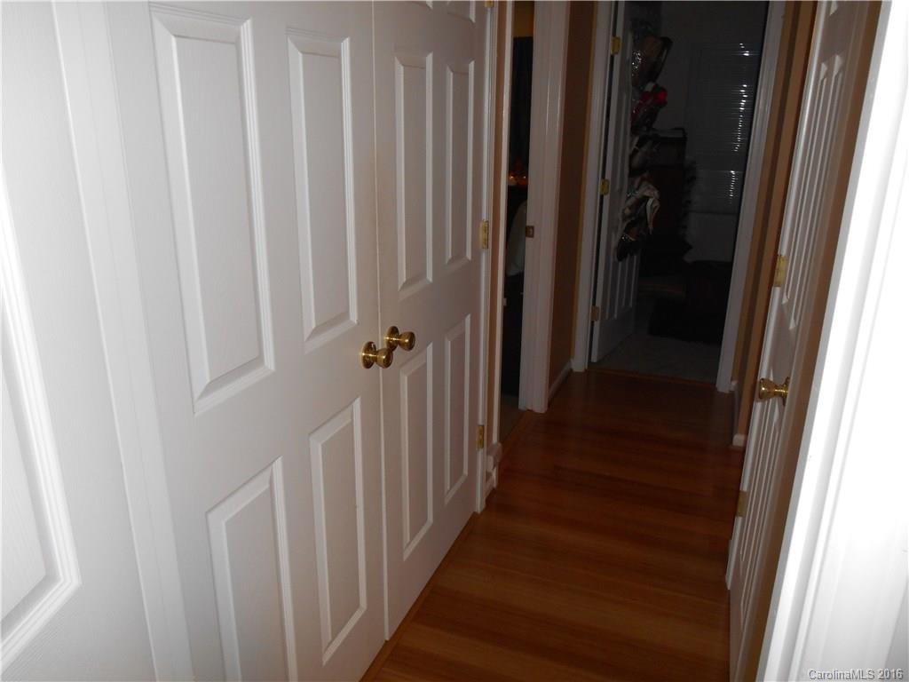 808 Valley Ridge Road Charlotte, NC 28214 - Photo 13 of 19 a view of a hallway with wooden floor and staircase