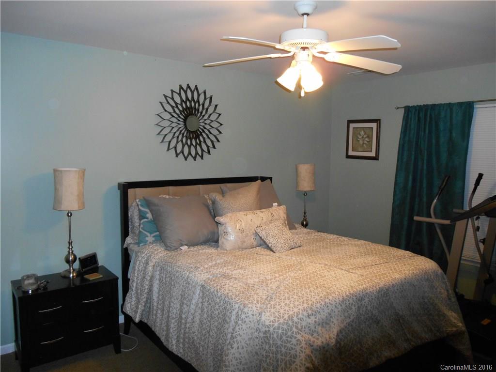 808 Valley Ridge Road Charlotte, NC 28214 - Photo 15 of 19 a bedroom with a bed and a lamp