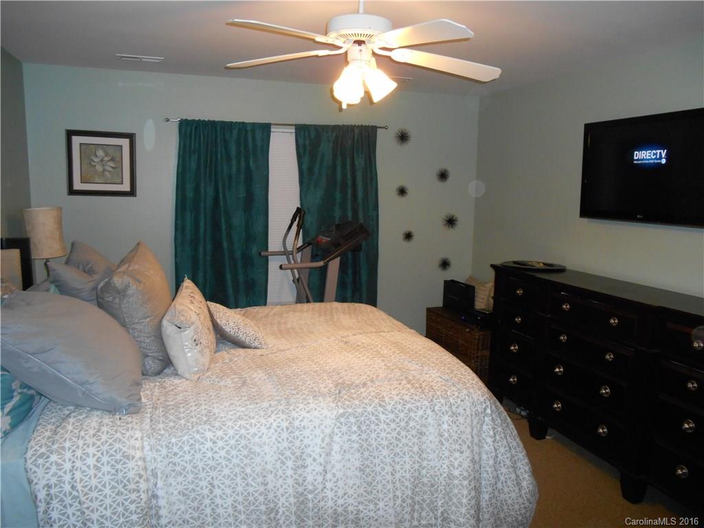 808 Valley Ridge Road Charlotte, NC 28214 - Photo 16 of 19 a bedroom with a bed and a flat tv screen on dresser