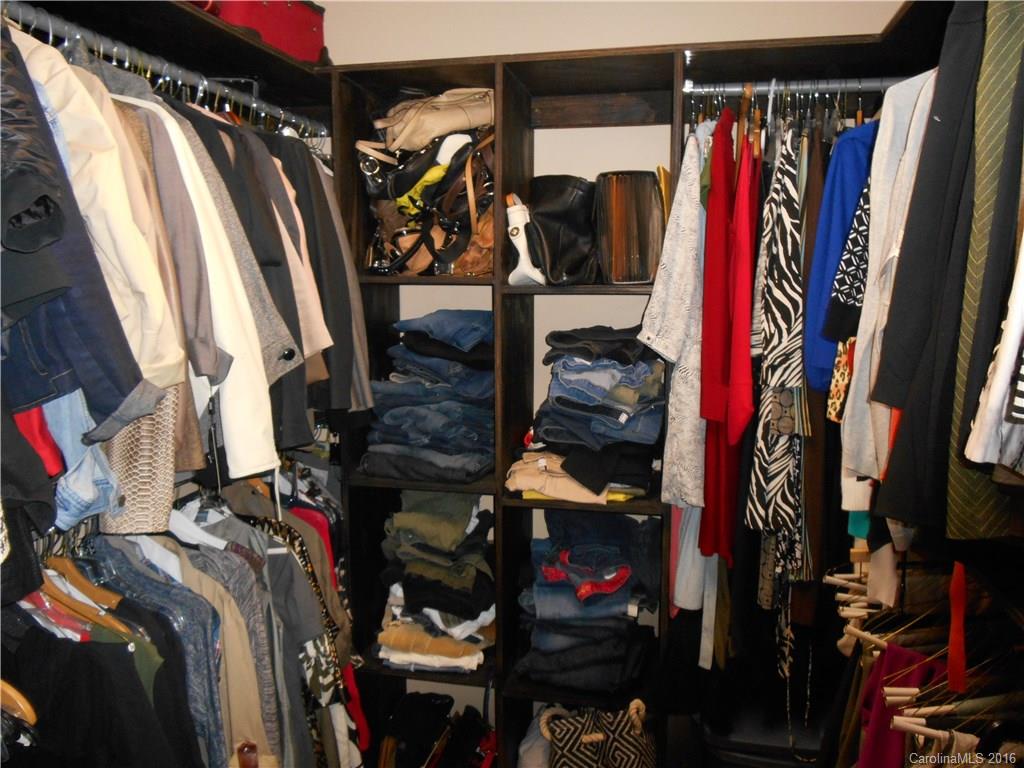 808 Valley Ridge Road Charlotte, NC 28214 - Photo 17 of 19 a view of walk in closet with clothes and shoes