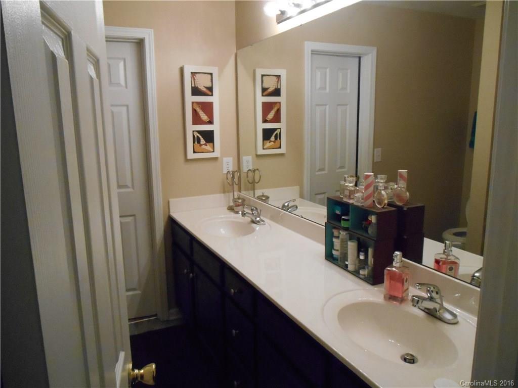 808 Valley Ridge Road Charlotte, NC 28214 - Photo 18 of 19 a bathroom with a double vanity sink and a mirror