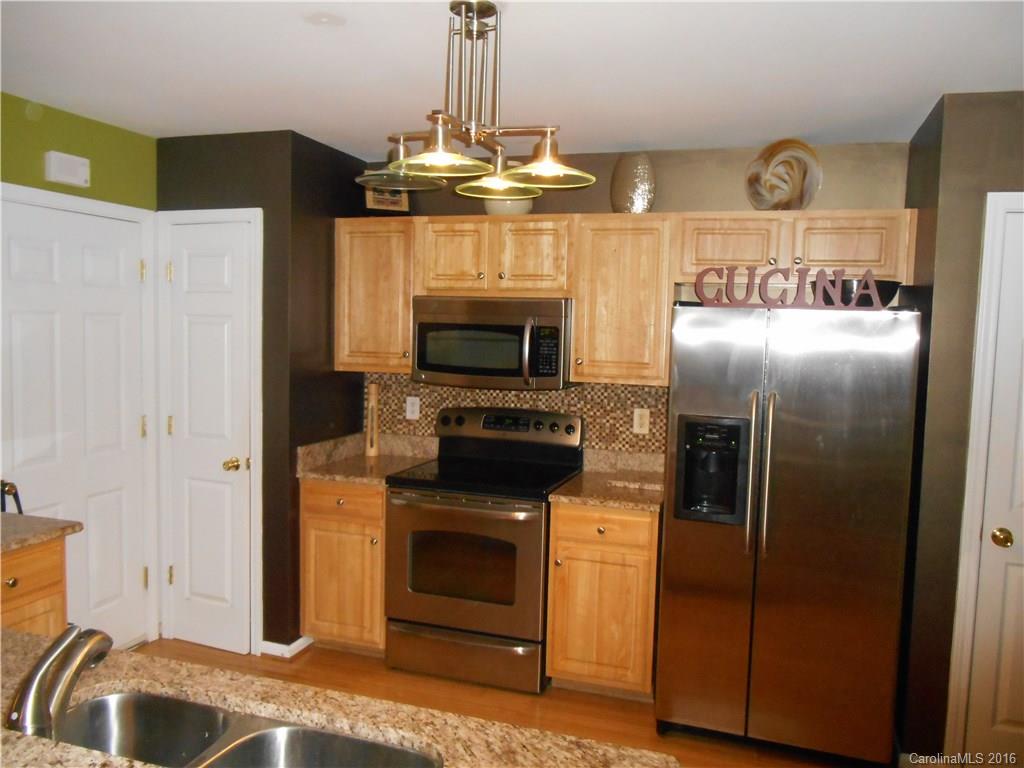 808 Valley Ridge Road Charlotte, NC 28214 - Photo 3 of 19 a kitchen with stainless steel appliances granite countertop a refrigerator a oven and a stove with wooden floor