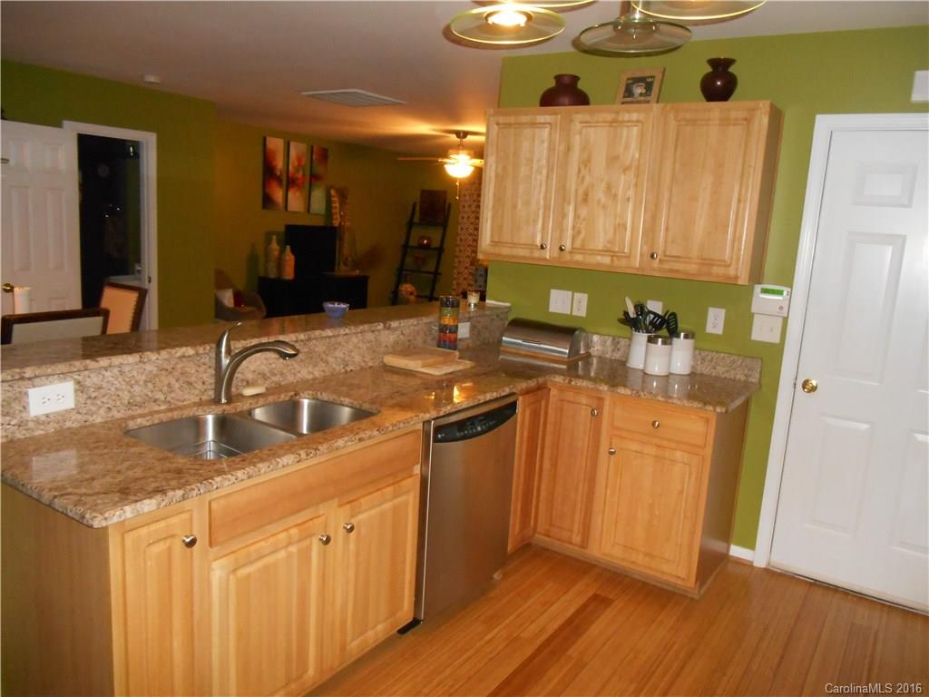 808 Valley Ridge Road Charlotte, NC 28214 - Photo 4 of 19 a kitchen with stainless steel appliances granite countertop a sink and a stove with wooden floor