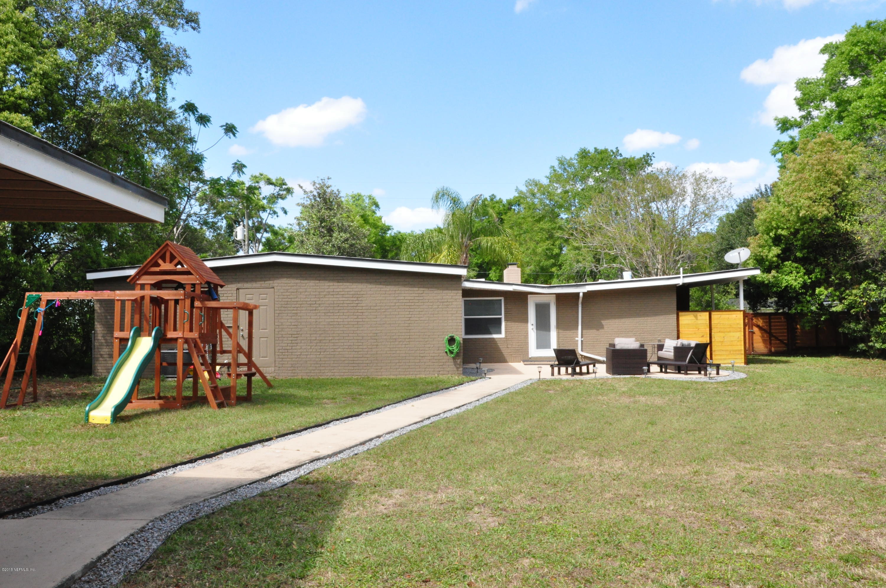 9822 Cunningham Road Jacksonville, FL 32246 - Photo 54 of 67 a view of a backyard with a slide and a slide