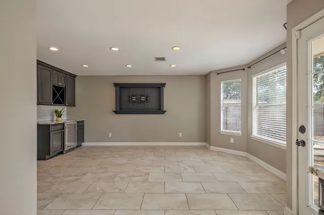 a view of livingroom with kitchen cabinets and flat screen tv