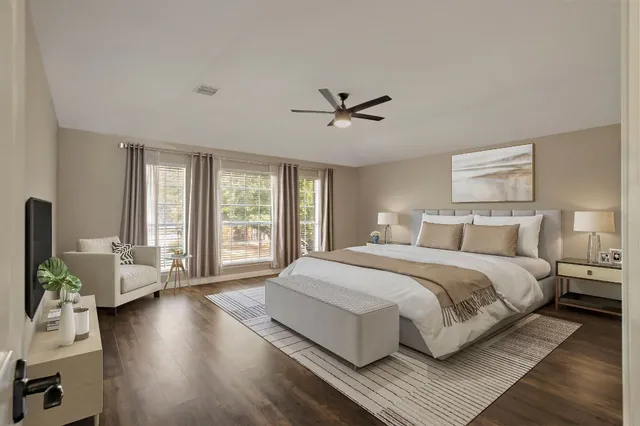 a spacious bedroom with a large bed and a large window