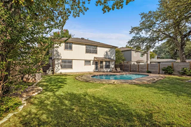 a view of a house with swimming pool and sitting area