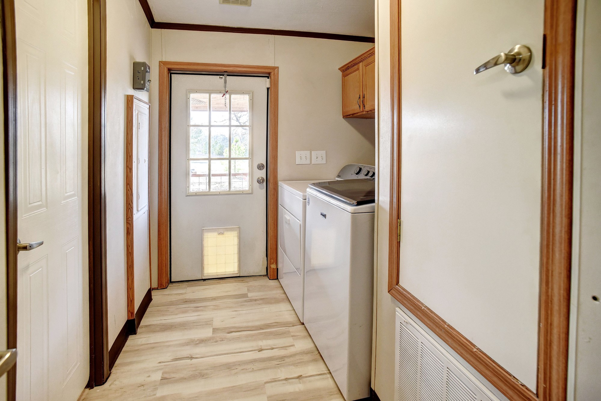 552 South Old Potato Road Paige, TX 78659 - Photo 31 of 40 Your laundry room comes complete with the washer and dryer, even a lockable doggie door for your fur babies!