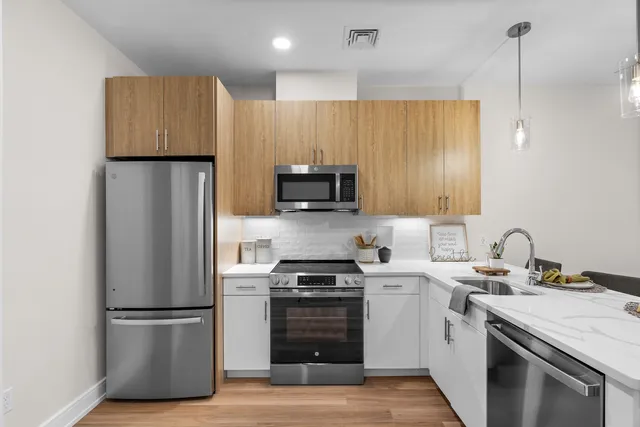 a kitchen with a sink stainless steel appliances and cabinets