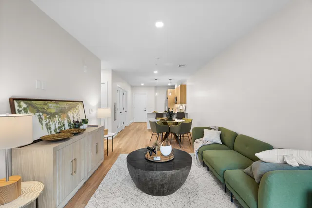 a living room with furniture and a wooden floor