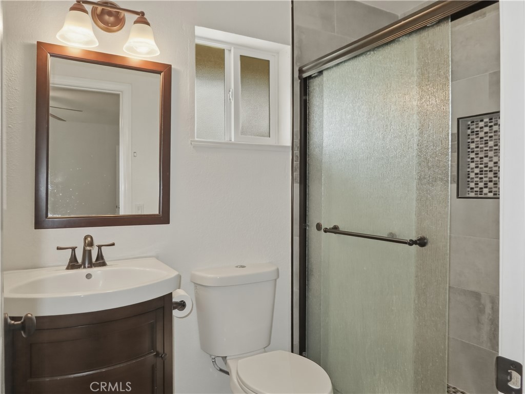 4409 Challen Avenue Riverside, CA 92503 - Photo 15 of 31 a bathroom with a sink toilet and shower