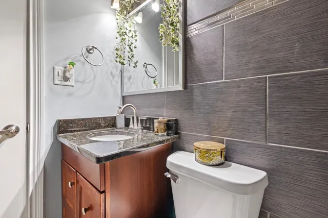 a bathroom with a sink a toilet and a mirror